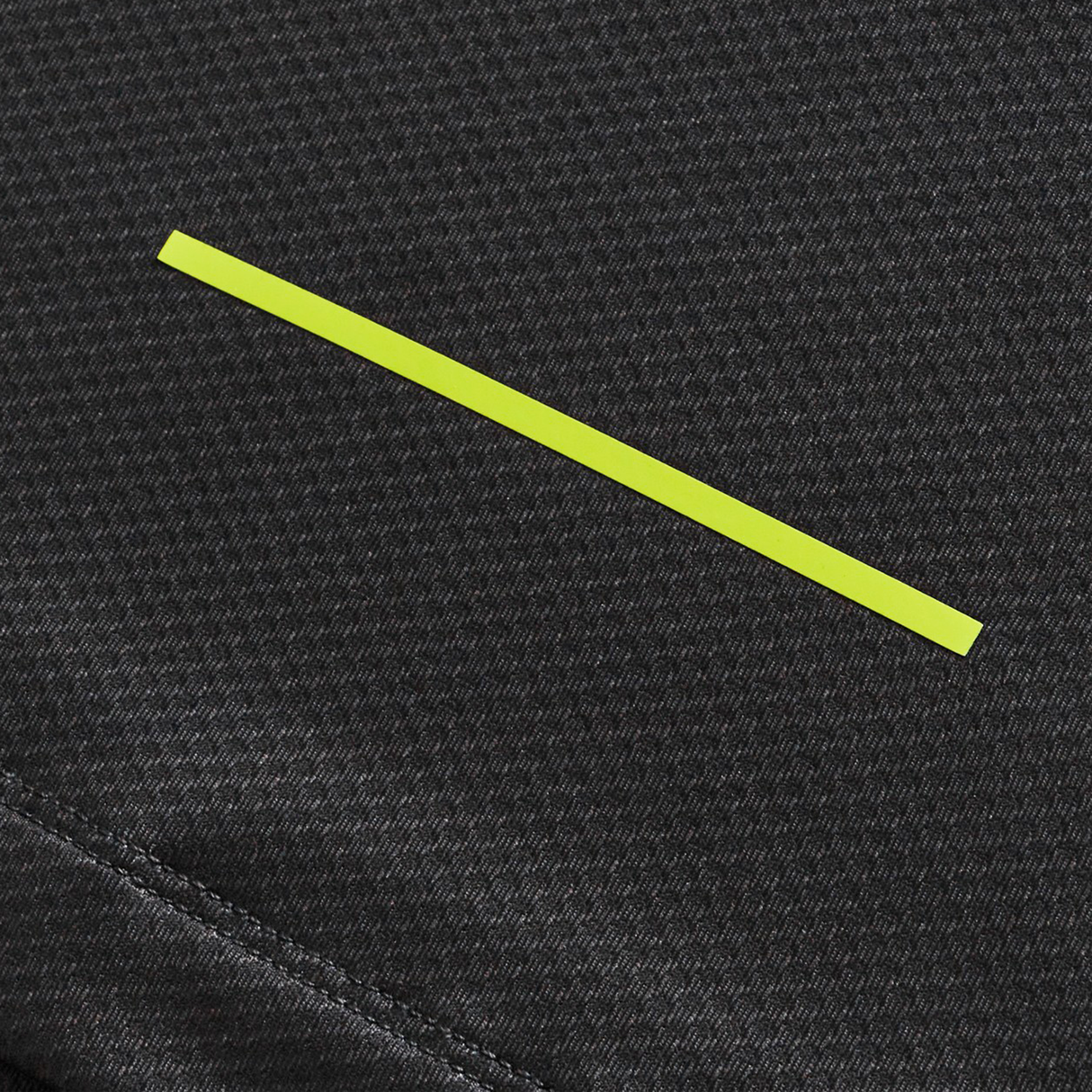 A yellow horizontal line on a textured dark gray fabric background, inspired by Canterbury's Tempo+ Training Tee (H225).