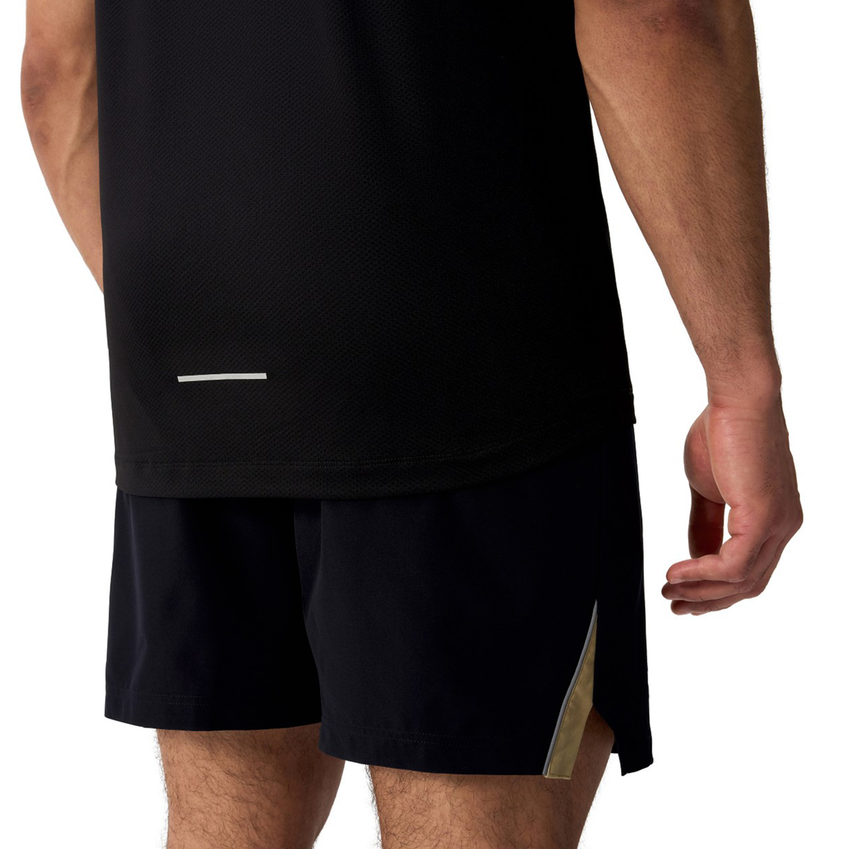 A person is seen from the back wearing Canterbury’s black Tempo+ Training Tank and matching shorts, featuring a small reflective strip and moisture-wicking fabric ideal for intense workouts.