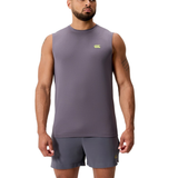 A man wears the Canterbury Tempo+ Training Tank in athletic fit, sleeveless and gray, with matching gray shorts, standing facing forward against a white background.