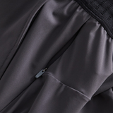 Close-up of black Canterbury Everest Woven Pants showcasing a visible zipper and gathered stitching, perfect for performance training or rugby.