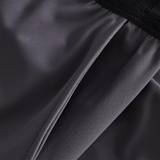 Close-up of a pocket on dark gray Canterbury Everest Woven Pants with an elastic waistband, designed for performance training.