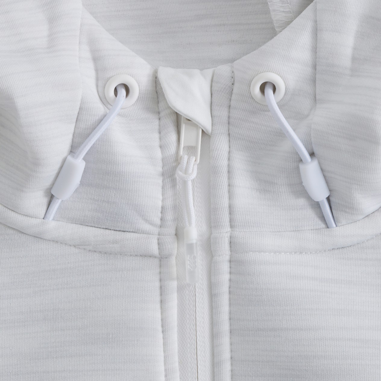 Close-up of the Everest Training Full-Zip Hoodie by Canterbury, highlighting the zipper, drawstrings, and grommets set against its textured athletic fabric.