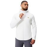 A man wearing the Everest Training Full-Zip Hoodie by Canterbury in white and dark gray pants stands against a plain white background.