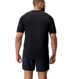 A man faces away in a black Everest Training Tee by Canterbury, featuring back ventilation holes and paired with black shorts—ideal for rugby players needing a performance fit.