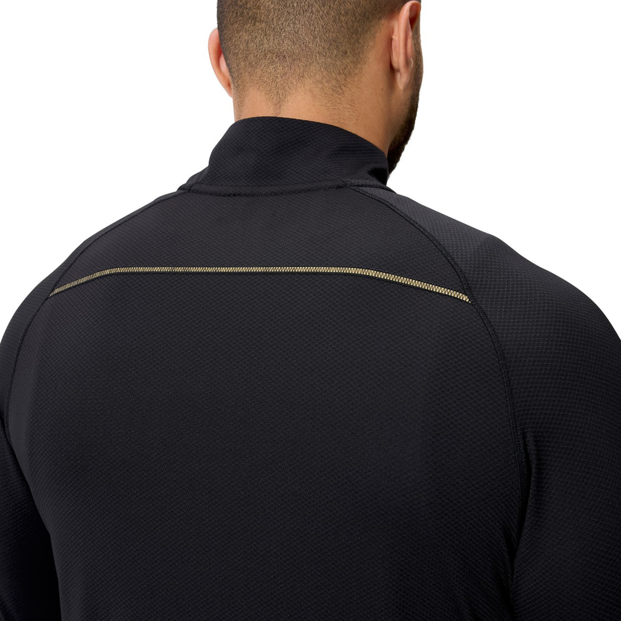 A person is shown from behind wearing the Canterbury Tempo+ 1/4 Zip Training Top, highlighting the black rugby training top’s textured fabric and horizontal stitched seam across the upper back.