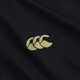 Close-up of the black Tempo+ 1/4 Zip Training Top by Canterbury, featuring a gold logo with three overlapping stylized “C” shapes—a lightweight performance fabric ideal for rugby training.