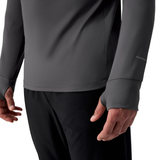 Person wearing a Canterbury Tempo+ 1/4 Zip Training Top in gray with thumb holes and black pants, torso shown.