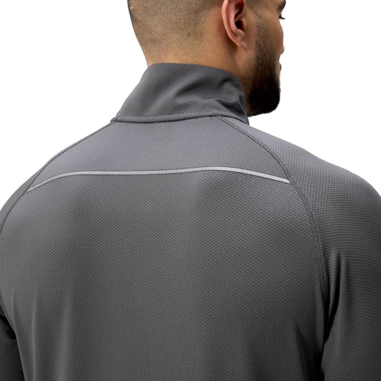 A man is shown from the back, highlighting the upper body and shoulders, wearing a gray Canterbury Tempo+ 1/4 Zip Training Top.