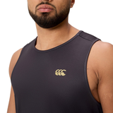 A man wears a black Tempo+ Singlet by Canterbury featuring a gold logo on the chest, shown from the shoulders up.