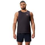A man stands facing forward wearing the black Tempo+ Singlet by Canterbury and black shorts against a white background.
