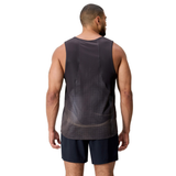 A man, facing away from the camera, wears the black Canterbury Tempo+ Singlet and matching shorts made with moisture-wicking fabric, set against a plain white background.