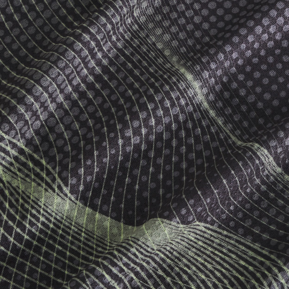 Close-up of black fabric from the Tempo+ Singlet by Canterbury, showing a moisture-wicking material with thin, wavy white lines and small dots forming an abstract geometric grid pattern.