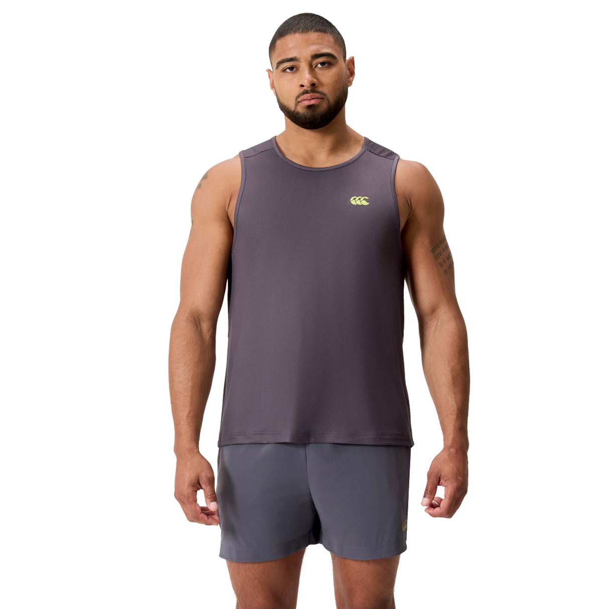 A man stands facing forward wearing the Canterbury Tempo+ Singlet in gray and matching gray shorts against a plain white background.