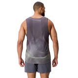 A man faces away, wearing the gray Canterbury Tempo+ Singlet and matching shorts made from moisture-wicking performance fabric, set against a white background.