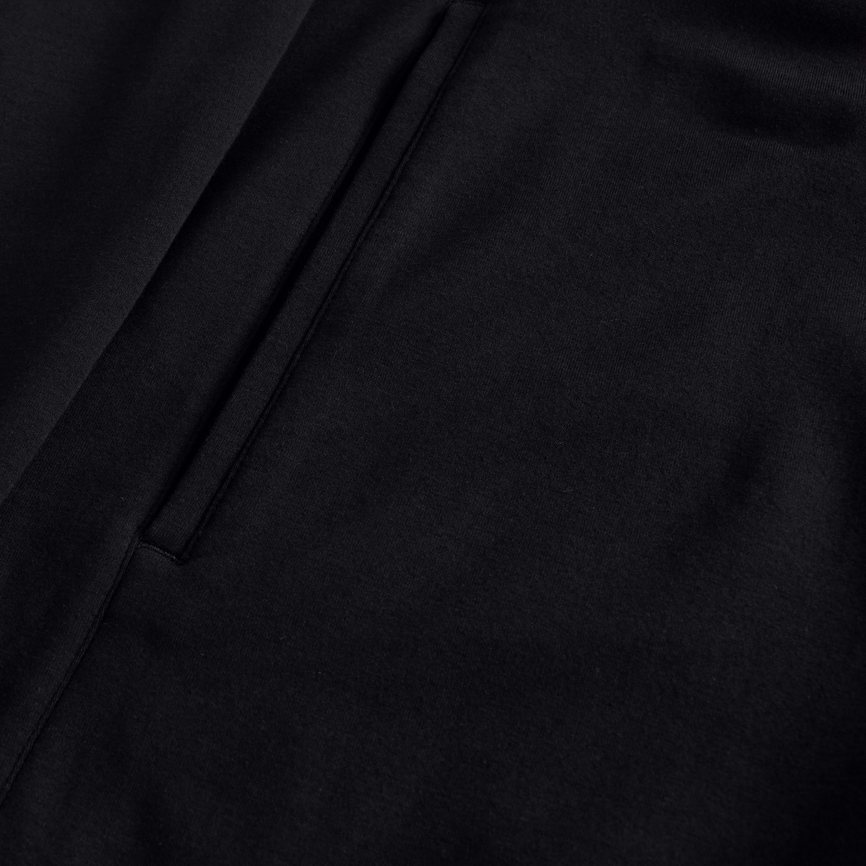 Close-up of the Canterbury Tempo+ Full-Zip Hoodie by Canterbury, a black lightweight stretch hoodie with a neatly stitched side pocket.