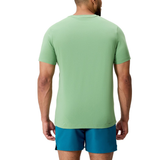 A man stands with his back to the camera, wearing a light green Uglies CCC Logo T-Shirt by Canterbury and blue shorts, set against a plain white background.