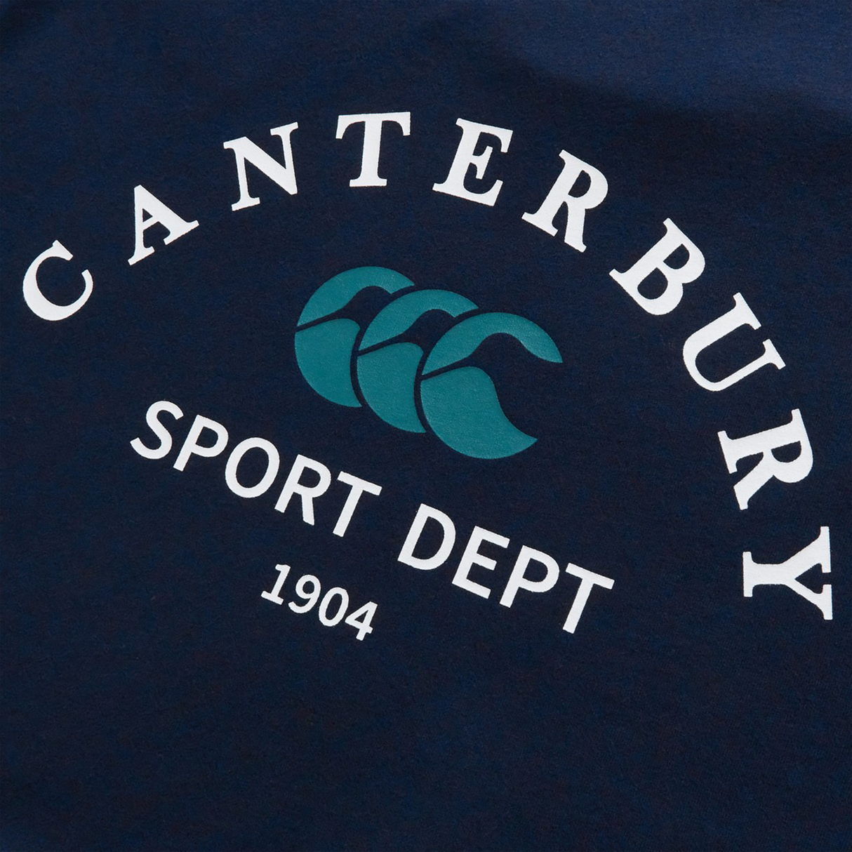 The Sport Dept. Logo T-Shirt by Canterbury is a navy cotton-blend tee with "CANTERBURY SPORT DEPT 1904" in white and a teal triple-C logo—ideal as a classic Canterbury rugby or casual athletic shirt.