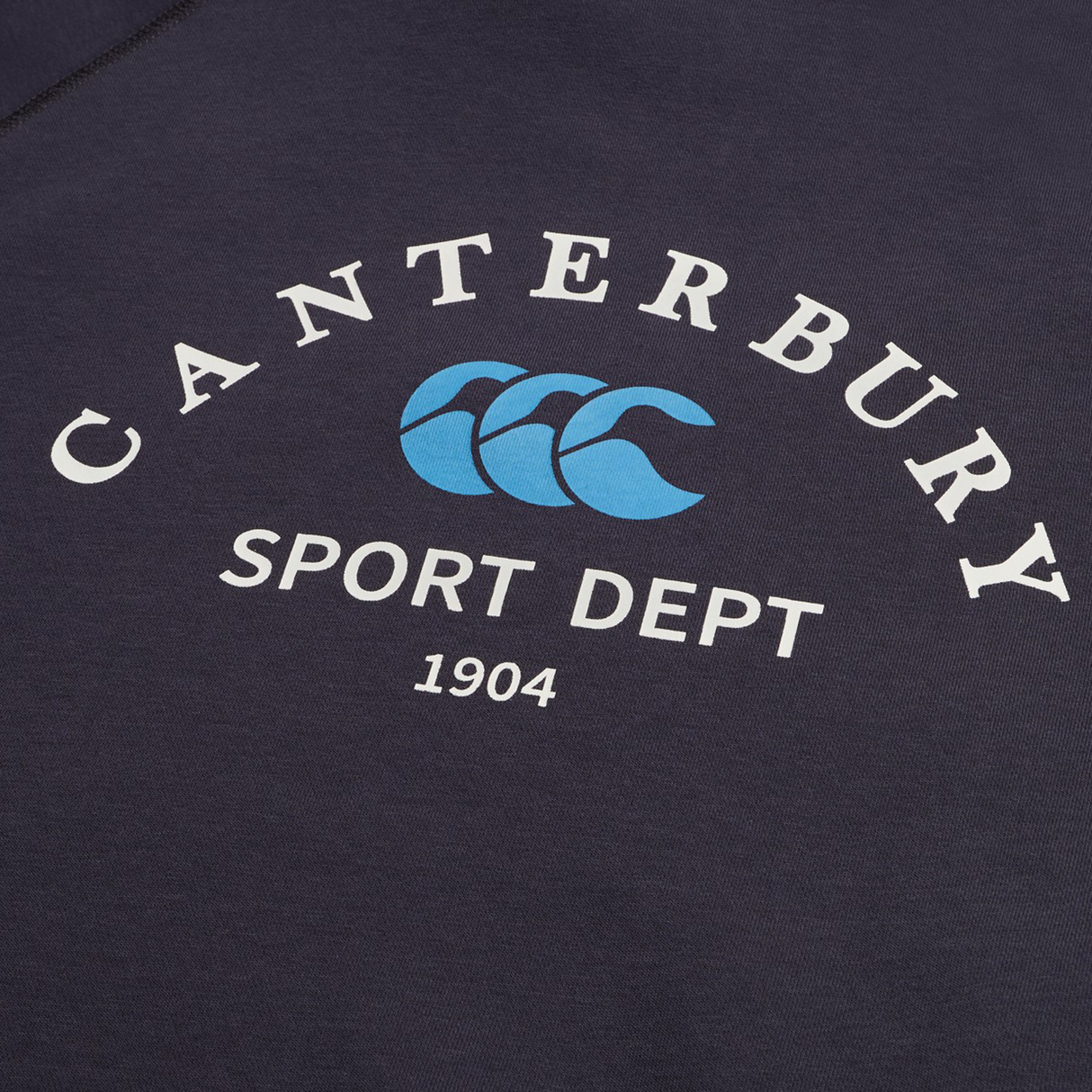 The Sport Dept. 1/4 Zip Sweater by Canterbury features navy fabric and "Canterbury Sport Dept 1904" with a blue triple-curved logo printed in bold white and blue lettering.