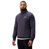 A man stands facing forward against a plain white background wearing the Sport Dept. 1/4 Zip Sweater by Canterbury and black pants, highlighting Canterbury’s classic Sport Dept style.