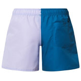 The Canterbury Women's Fundamentals 3" Harletic Shorts feature a two-tone design with a light purple left side, blue right side, elastic waistband, and a single back pocket, inspired by athletic training wear.