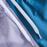 Close-up of two white drawstrings on color-blocked purple and blue fabric from the Canterbury Women's Fundamentals 3" Harletic Shorts, ideal for athletic training.