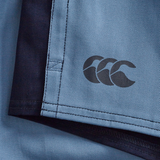 Close-up of the Fundamental Harlequin Drill 3" Shorts by Canterbury in light blue with navy edges, a stitched seam, and black CCC logo—ideal for fans of classic Canterbury rugby shorts.