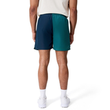 A man is seen from the back wearing Canterbury Fundamental Harletic 3" Shorts, a light shirt, white socks, and white athletic shoes against a plain white backdrop.