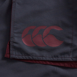 Close-up of Fundamental Harletic 3" Shorts by Canterbury, featuring dark fabric and a maroon Canterbury logo with three overlapping stylized Cs.
