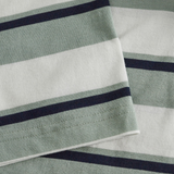 Close-up of two overlapping pieces of fabric with green, white, and dark blue stripes from the Fundamental Yarn Dye Stripe T-Shirt by Canterbury, featuring a rugby-inspired design.