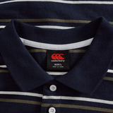 A close-up of the Fundamental Yarn Dye Stripe Polo by Canterbury in navy, showing white buttons and a brand label with size L and "Made in China.