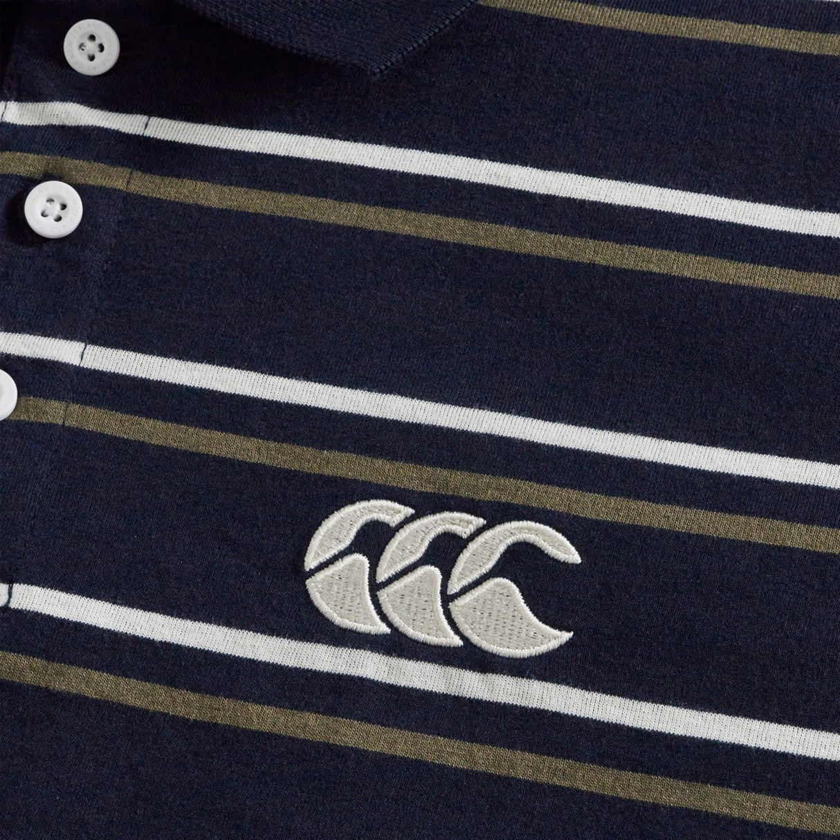 Close-up of the Canterbury Yarn Dye Stripe Polo by Canterbury in navy blue, showcasing white and olive green stripes, classic white buttons, and an embroidered white logo with three overlapping shapes—a perfect choice for fans of timeless rugby polo style.