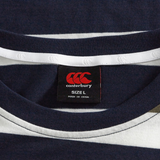 Close-up of the Fundamental Yarn Dye Stripe T-Shirt by Canterbury in navy blue and white, rugby-inspired, highlighting the neck area and black label showing size L and "Made in China" text.