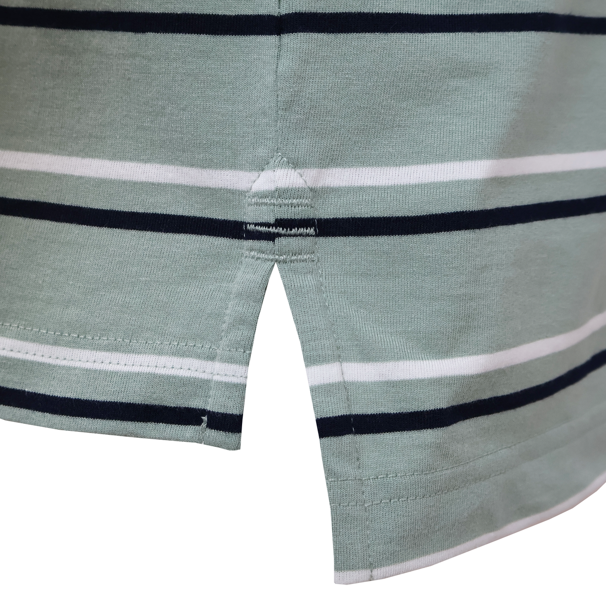 Close-up of the Fundamental Yarn Dye Stripe Polo by Canterbury in light green with white and black stripes, featuring Canterbury-inspired side slits and reinforced hem stitching.