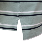 Close-up of the Fundamental Yarn Dye Stripe Polo by Canterbury in light green with white and black stripes, featuring Canterbury-inspired side slits and reinforced hem stitching.