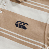 Close-up of the Fundamental Engineered Stripe Polo by Canterbury in beige and white, featuring three white buttons and a black embroidered logo with three overlapping "C" shapes.