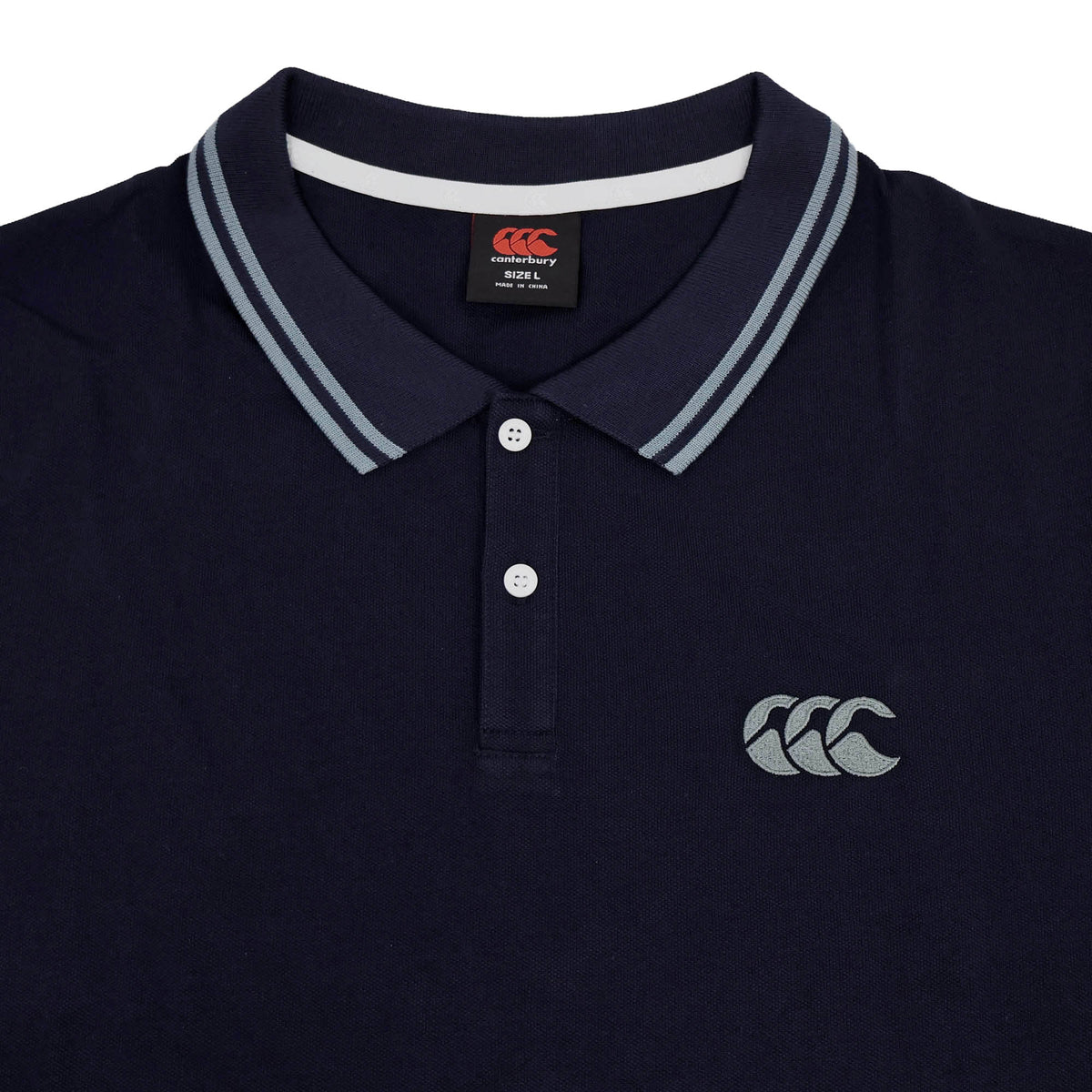 Canterbury Solid Dye Polo in navy blue featuring a white-striped collar, two-button placket, and Canterbury logo on the left chest for an athletic look.