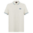 The Canterbury Fundamental Solid Dye Polo is cream-colored with a rugby-inspired look, featuring blue and white striped collar and cuffs, plus a blue logo on the left chest.