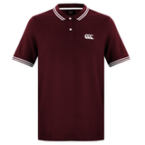 The Canterbury Fundamental Solid Dye Polo is a maroon, short-sleeve shirt with white collar and sleeve trim, a white Canterbury logo on the left chest, and a rugby-inspired design.