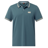 The Canterbury Solid Dye Polo by Canterbury is a blue, short-sleeve rugby-inspired shirt with a white striped collar and sleeve cuffs, featuring a white logo on the left chest for an athletic look.