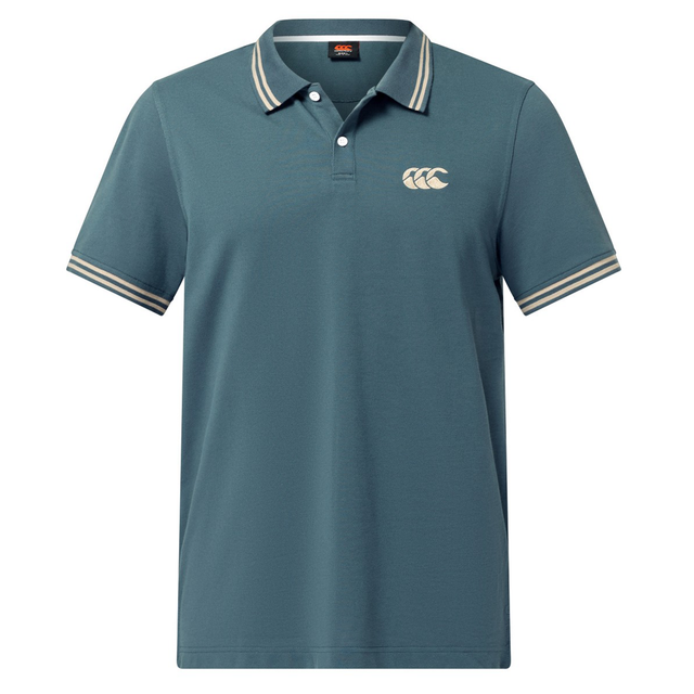 The Canterbury Solid Dye Polo by Canterbury is a blue, short-sleeve rugby-inspired shirt with a white striped collar and sleeve cuffs, featuring a white logo on the left chest for an athletic look.