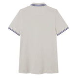 The Canterbury Solid Dye Polo by Canterbury is shown from the back, featuring a classic white short-sleeve design with blue and white stripes on the collar and sleeve cuffs.