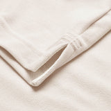 Close-up of two off-white towels stacked, showcasing texture and edge stitching reminiscent of the refined finishes featured on the Canterbury Solid Dye Polo by Canterbury.