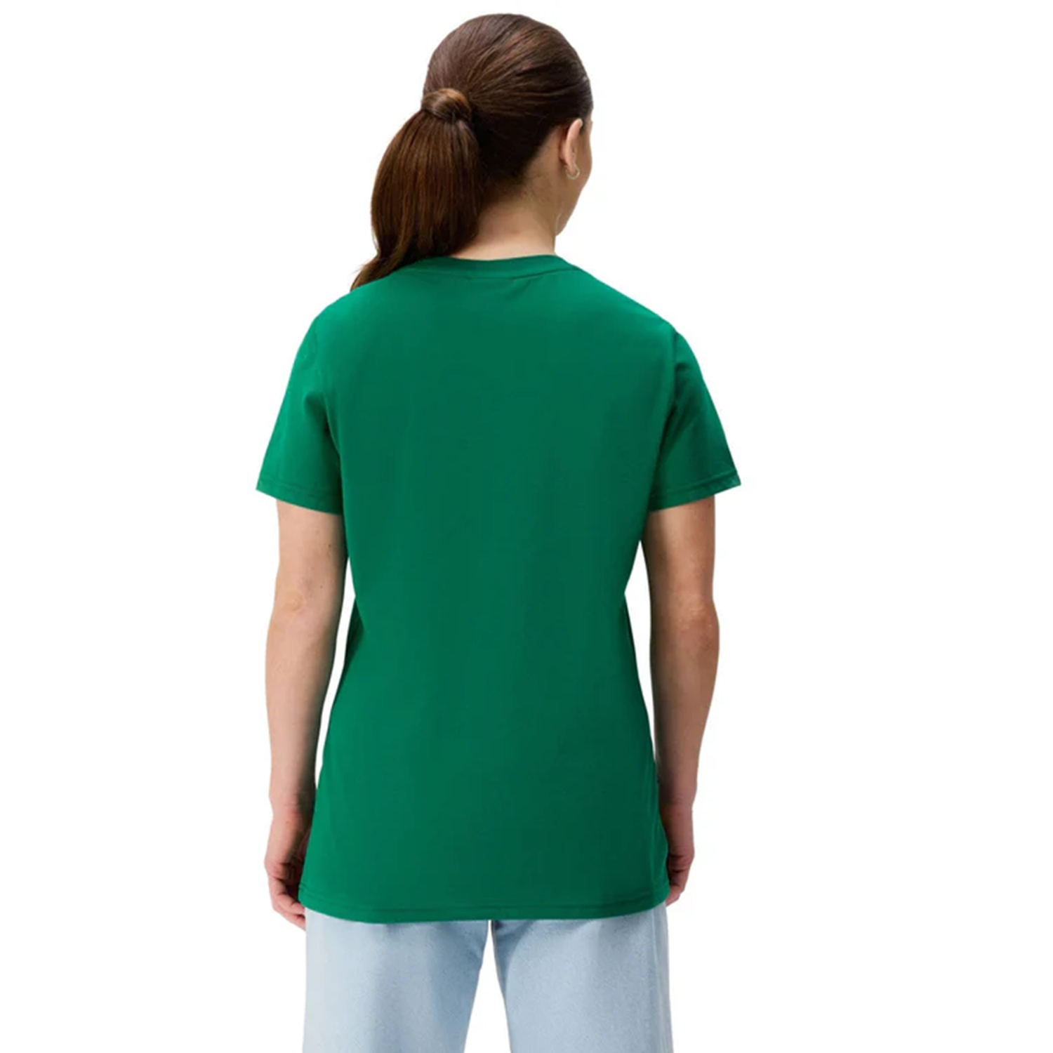 A person stands with their back to the camera, wearing the Women's Ireland 25/26 Cotton Team T-Shirt by Canterbury and light blue jeans, set against a plain white background.