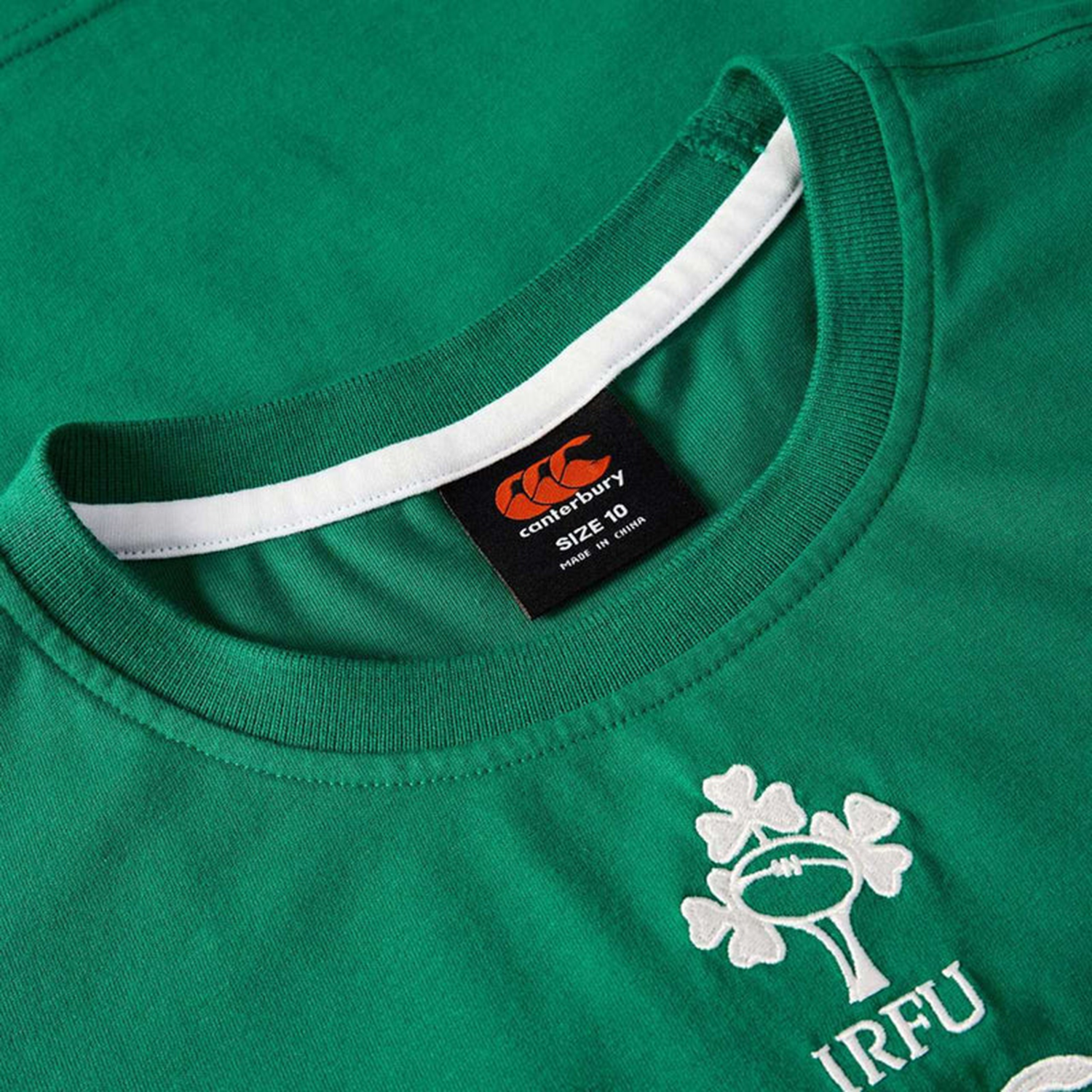 Close-up of the green Women's Ireland 25/26 Cotton Team T-Shirt by Canterbury, featuring the IRFU logo and an inner collar size label, celebrating the Ireland women's rugby team.