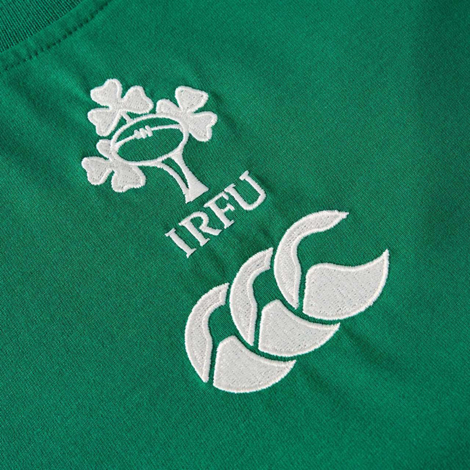 Close-up of the Canterbury logo and Ireland Rugby Football Union crest embroidered on soft green cotton, featured on the Women's Ireland 25/26 Cotton Team T-Shirt by Canterbury.