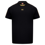 The Canterbury Tempo+ Drill Top is a black short-sleeve rugby shirt featuring a gold chest logo and gold shoulder stitching, shown on a plain white background.