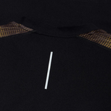 Close-up of the black Tempo+ Drill Top by Canterbury, featuring a central vertical reflective strip and brown patterned mesh accents—moisture-wicking and ideal for performance training.