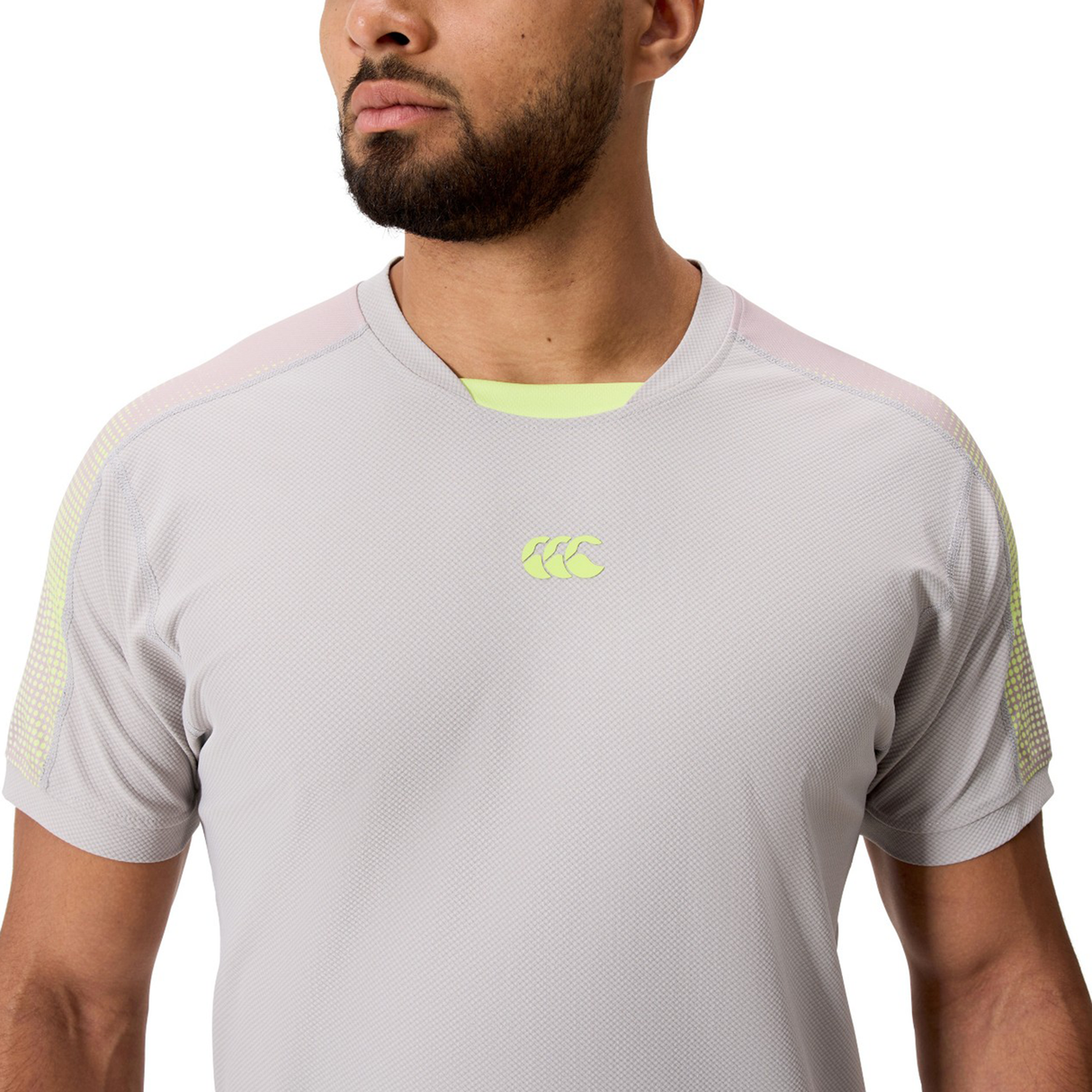 A man wearing the Canterbury Tempo+ Drill Top in light gray with a subtle chest logo, standing against a plain background.