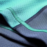 Close-up of turquoise and dark gray athletic fabric with visible stitching, from the Ireland 26/27 Summer Tour "Baltic" Training Test Jersey by Canterbury.