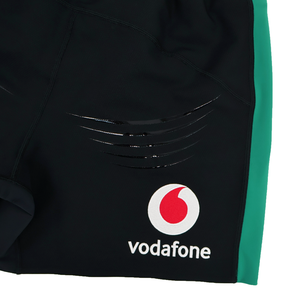 Close-up of the Ireland 25/26 Alternate Match Short by Canterbury—black rugby shorts with a green side panel, Vodafone logo, and black stripes. Perfect for match day.